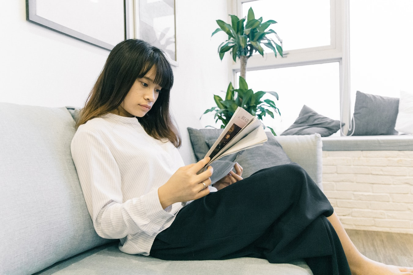 Woman sitting on couch reading about API security news