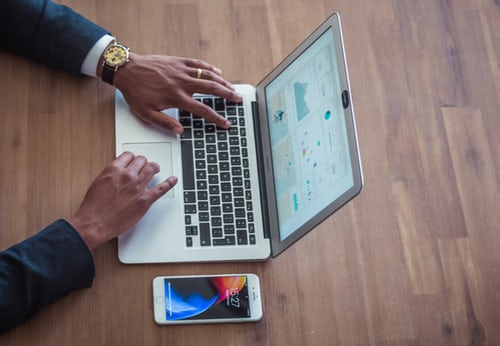 Man in suite working on laptop