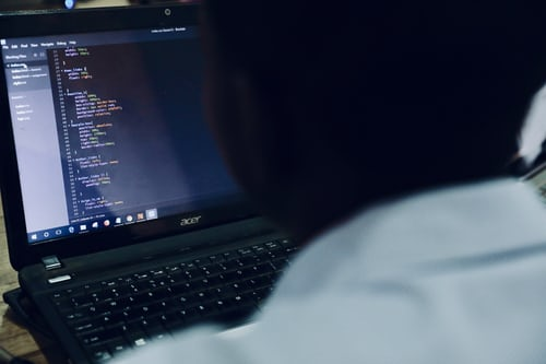 Person coding on laptop