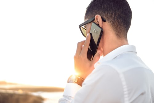 Man talking on cell phone outside