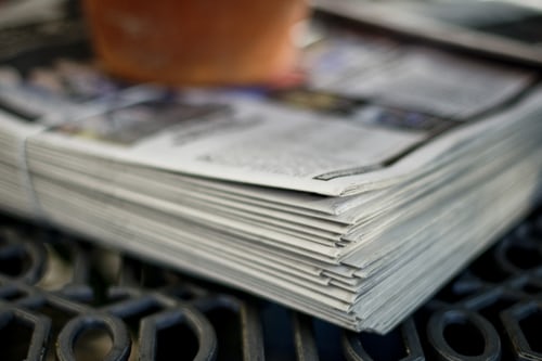 Stacked newspapers on table