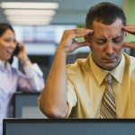 businessman irritated with loud coworker