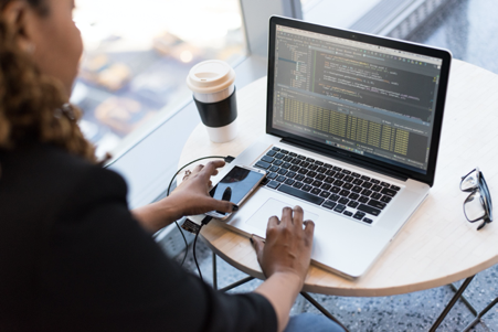 Woman typing computer code