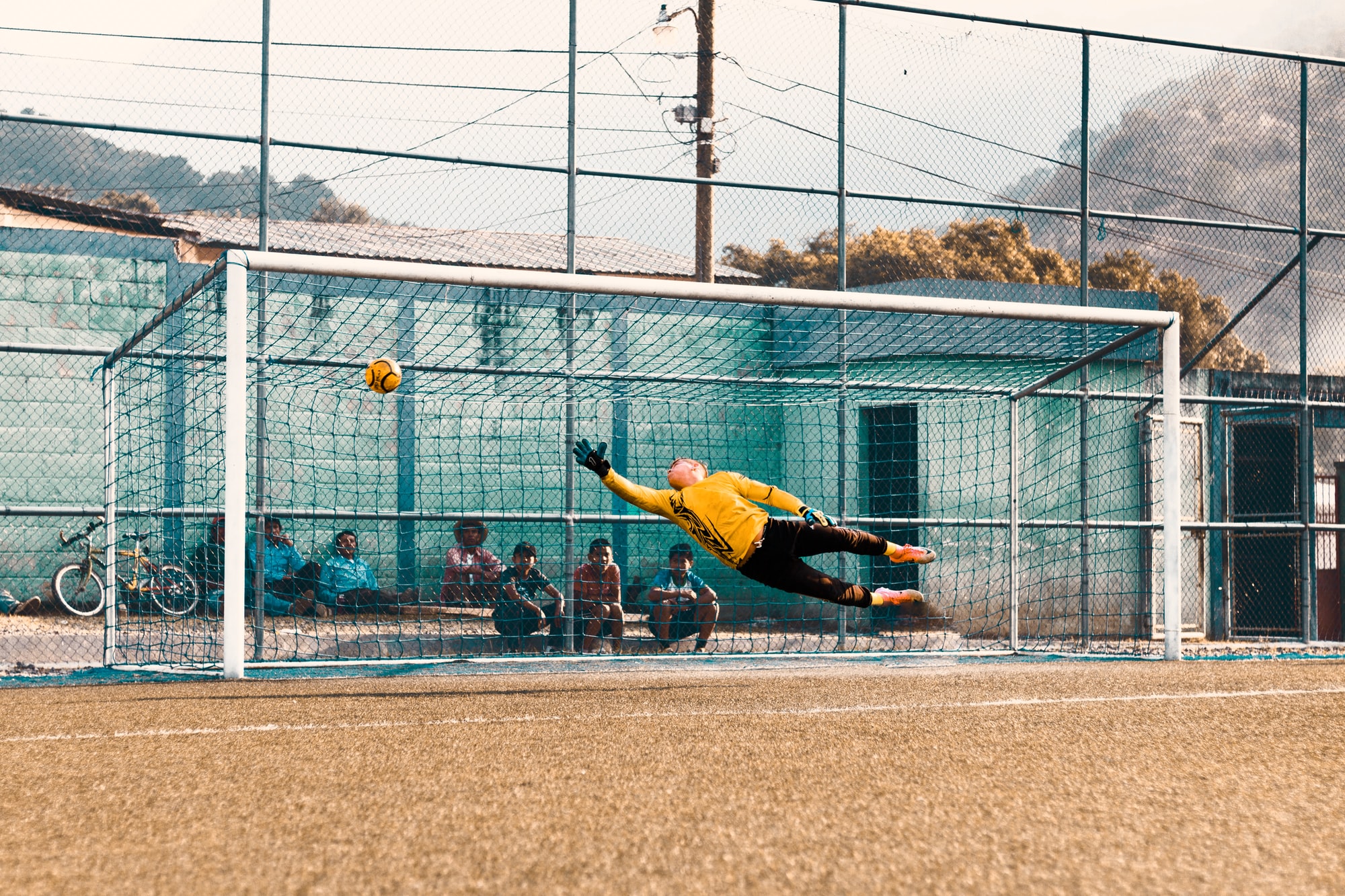Soccer goalie reaching for ball