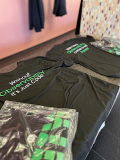 Observability t-shirts on display